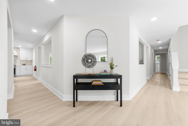 corridor featuring recessed lighting, light wood finished floors, and baseboards