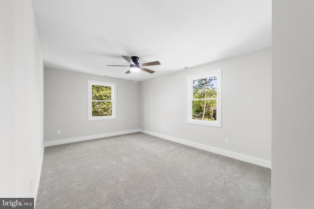 empty room featuring carpet floors, baseboards, and ceiling fan