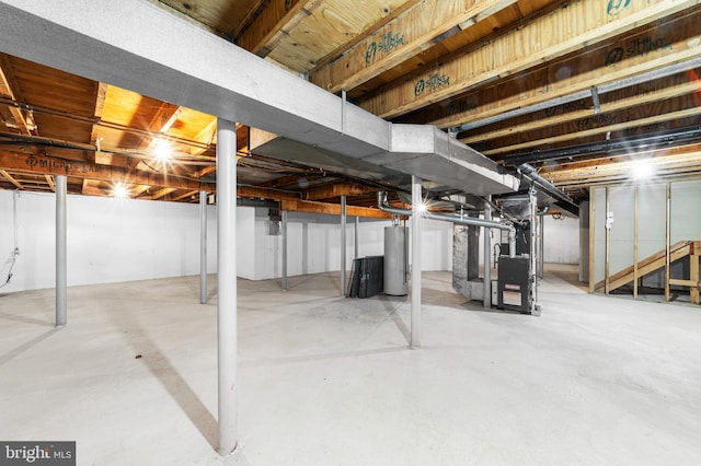 unfinished below grade area featuring heating unit and water heater