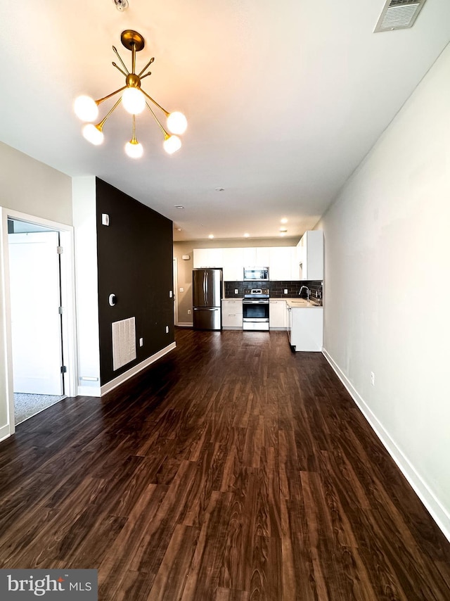 989 S Buchanan St Unit 221, Arlington, VA 22204 - unfurnished living room featuring a sink, a chandelier, visible vents, baseboards, and dark wood finished floors