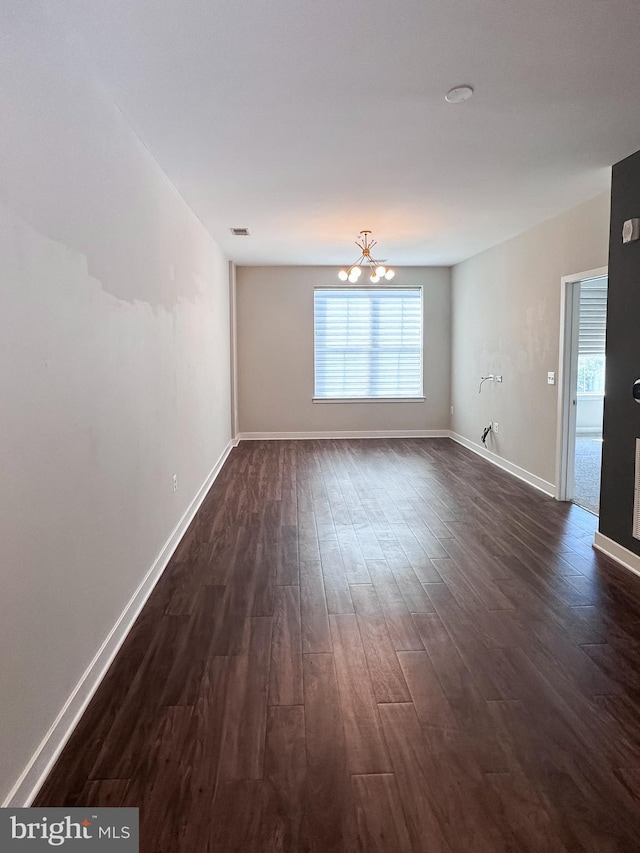 989 S Buchanan St Unit 221, Arlington, VA 22204 - empty room featuring dark wood-style floors, a notable chandelier, baseboards, and visible vents