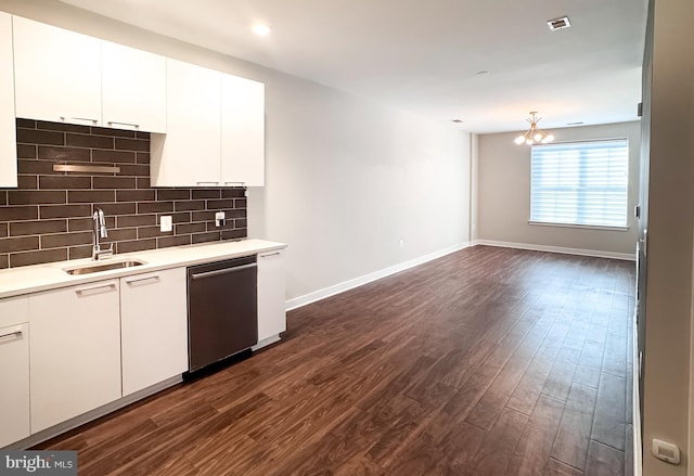 989 S Buchanan St Unit 221, Arlington, VA 22204 - kitchen with stainless steel dishwasher, light countertops, backsplash, a sink, and dark wood-style floors