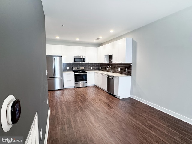 989 S Buchanan St Unit 221, Arlington, VA 22204 - kitchen featuring dark wood-style floors, a sink, appliances with stainless steel finishes, and decorative backsplash