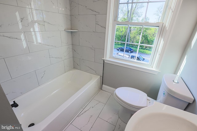 full bath featuring toilet, baseboards, and marble finish floor