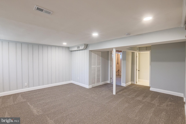 finished below grade area with visible vents, carpet flooring, baseboards, and recessed lighting