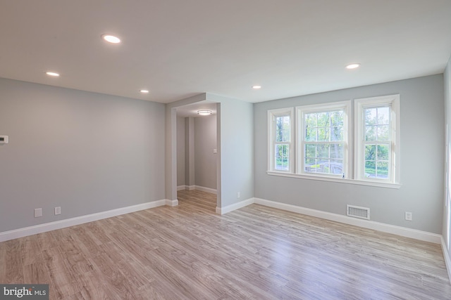 empty room with visible vents, recessed lighting, baseboards, and wood finished floors