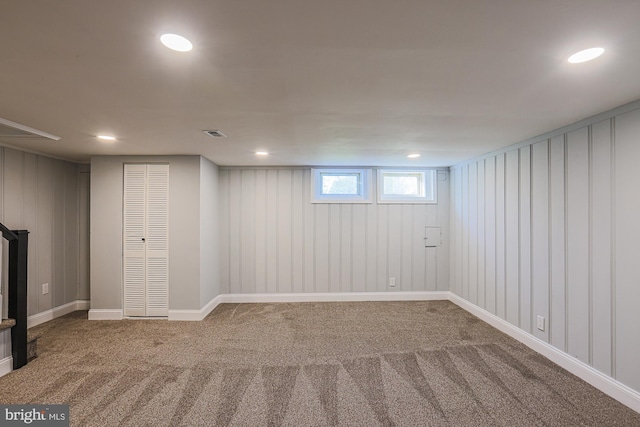 below grade area featuring carpet floors, recessed lighting, baseboards, and visible vents