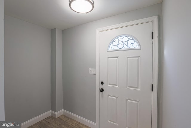 entrance foyer featuring baseboards and wood finished floors