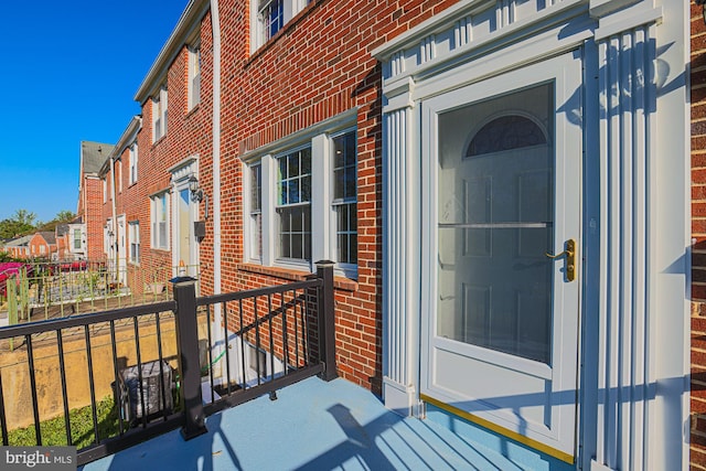 entrance to property featuring brick siding and a residential view