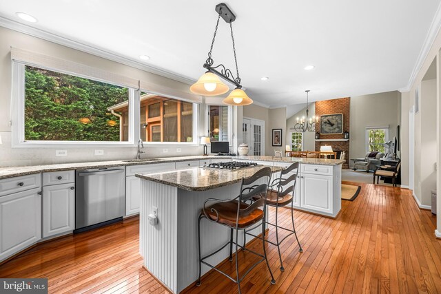 9 Selsed Garth, Lutherville Timonium, MD 21093 - kitchen featuring a kitchen island, appliances with stainless steel finishes, a sink, a peninsula, and ornamental molding
