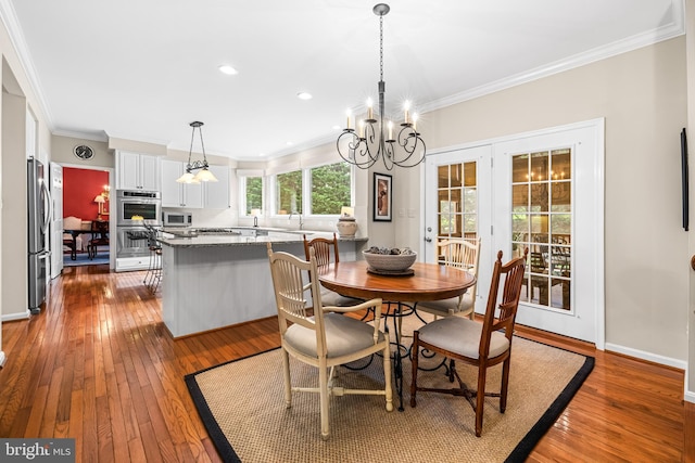 9 Selsed Garth, Lutherville Timonium, MD 21093 - dining space featuring baseboards, ornamental molding, dark wood-style flooring, and a chandelier