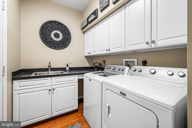 9 Selsed Garth, Lutherville Timonium, MD 21093 - laundry area featuring wood finished floors, a sink, cabinet space, and washing machine and dryer
