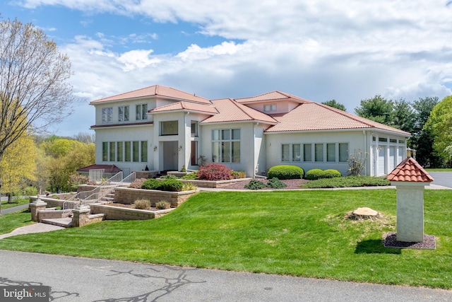 23 Deerfield Rd, Lancaster, PA 17603 - view of front of property featuring stucco siding, a front yard, a tile roof, and a garage