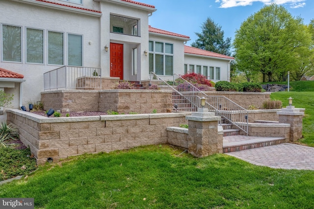23 Deerfield Rd, Lancaster, PA 17603 - exterior space featuring a tile roof, a front yard, and stucco siding