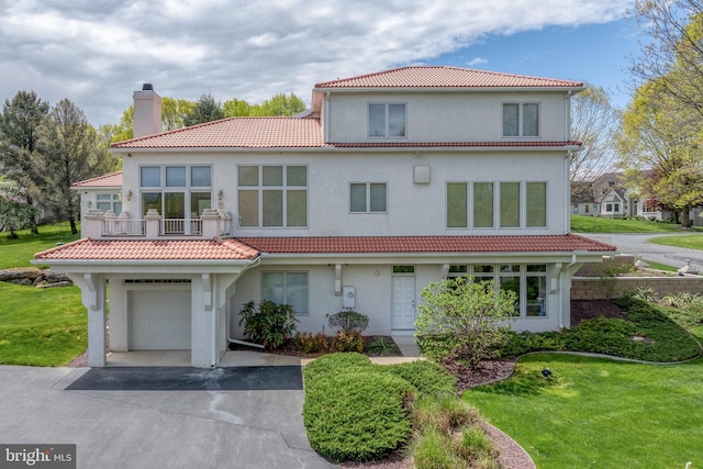23 Deerfield Rd, Lancaster, PA 17603 - view of front facade featuring a front lawn, a garage, driveway, a tiled roof, and a chimney