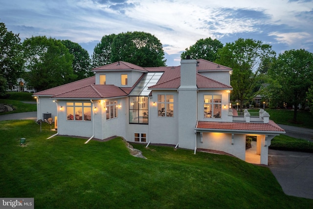 23 Deerfield Rd, Lancaster, PA 17603 - back of property featuring a tile roof, a yard, stucco siding, and a chimney