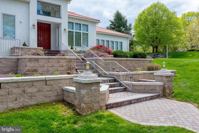 23 Deerfield Rd, Lancaster, PA 17603 - entrance to property with stucco siding, a tiled roof, and a yard