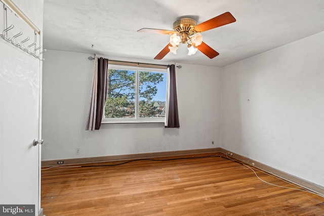 unfurnished room with light wood-style floors, baseboards, and ceiling fan