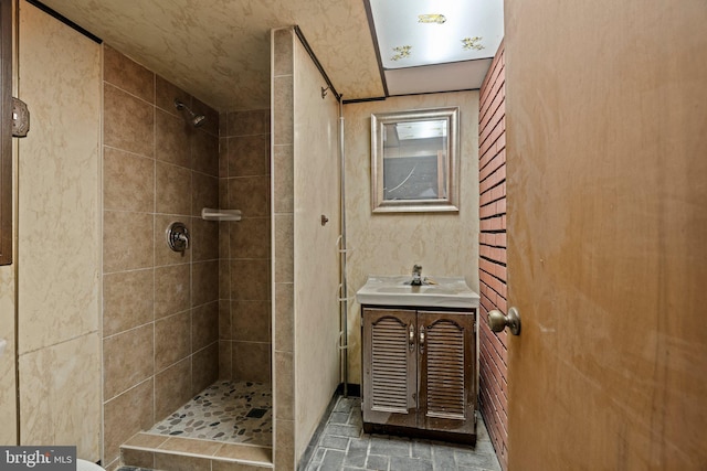 full bathroom with vanity and tiled shower