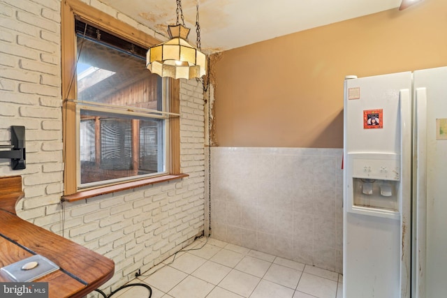 bathroom featuring tile patterned flooring, wainscoting, and tile walls