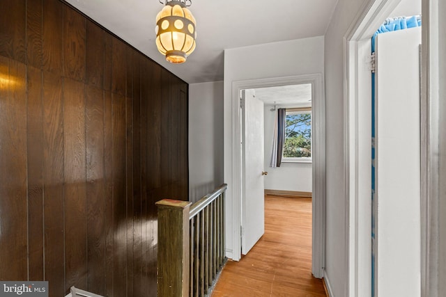 hallway with baseboards and light wood finished floors