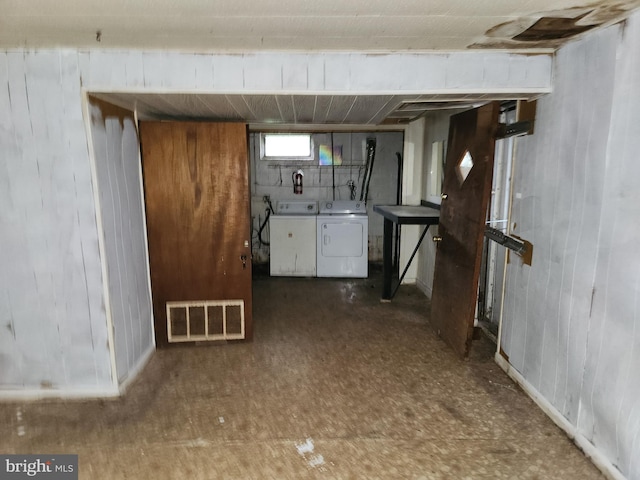 130 5th Ave, Baltimore, MD 21227 - below grade area featuring washer and clothes dryer, wooden walls, and tile patterned floors