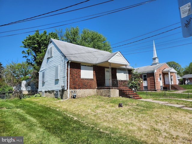 130 5th Ave, Baltimore, MD 21227 - view of front of house with brick siding and roof with shingles