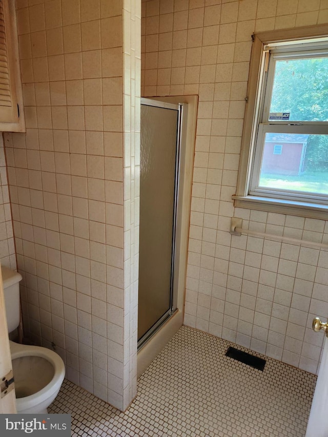 15498 Fleming St, King George, VA 22485 - full bathroom with toilet, tile patterned flooring, tile walls, and a shower stall