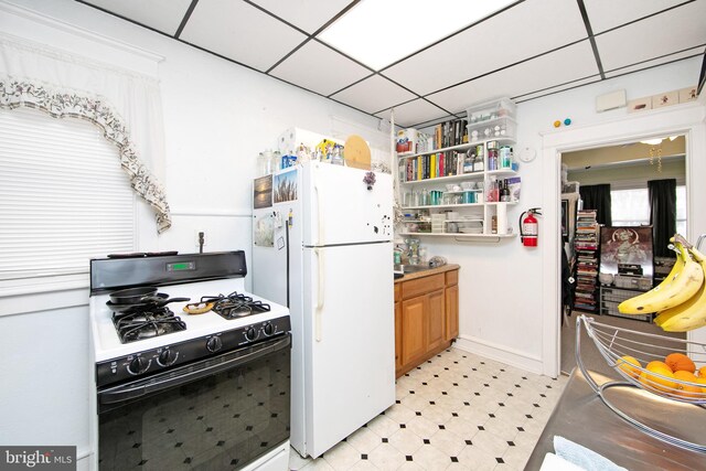 1104 High St, Haddon Heights, NJ 08035 - kitchen with gas range, freestanding refrigerator, light floors, open shelves, and a drop ceiling
