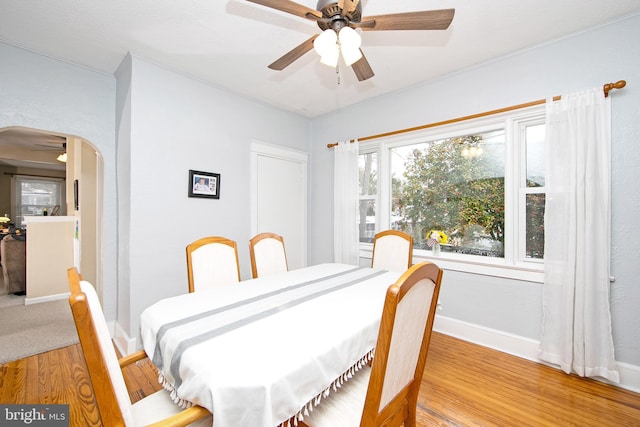 1104 High St, Haddon Heights, NJ 08035 - dining area with arched walkways, a ceiling fan, light wood-style floors, and baseboards