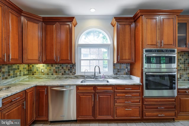 6732 Baron Rd, Mclean, VA 22101 - kitchen featuring stainless steel appliances, a sink, light stone counters, backsplash, and ornamental molding