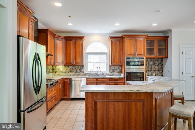 6732 Baron Rd, Mclean, VA 22101 - kitchen featuring stainless steel appliances, a sink, crown molding, brown cabinets, and decorative backsplash