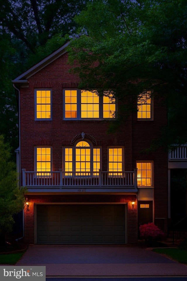 6732 Baron Rd, Mclean, VA 22101 - georgian-style home with brick siding, an attached garage, and driveway