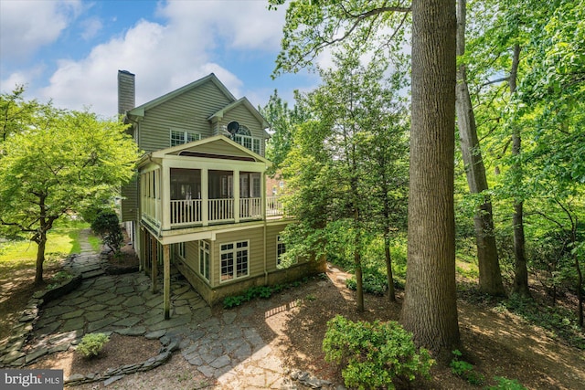 6732 Baron Rd, Mclean, VA 22101 - back of property featuring a chimney, a patio, and a sunroom