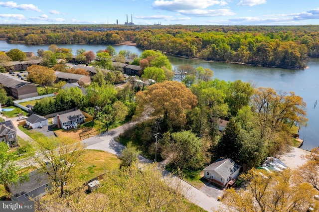 aerial view featuring a wooded view and a water view