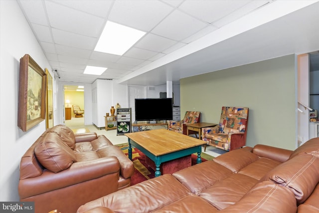 living area with a drop ceiling