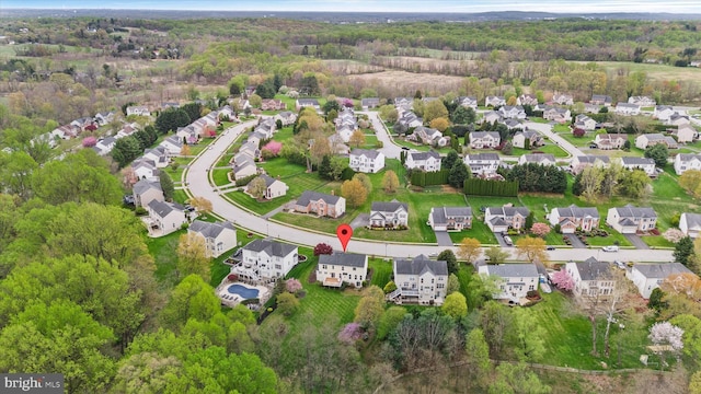 bird's eye view with a wooded view and a residential view