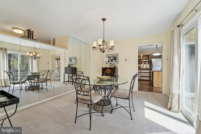 carpeted dining area featuring a notable chandelier