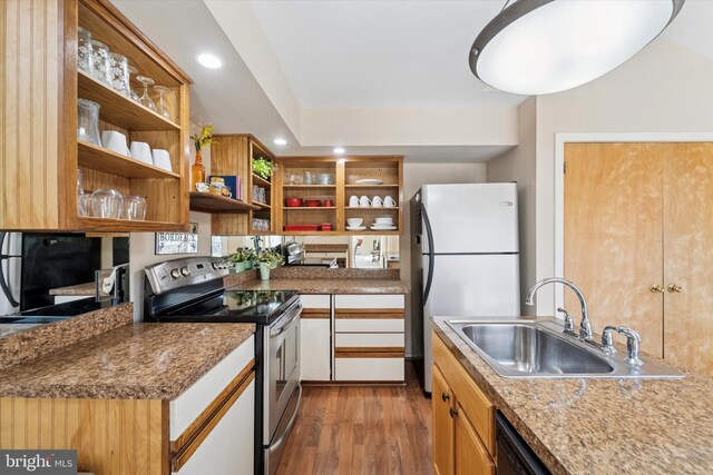 kitchen featuring dark wood-style flooring, open shelves, stainless steel range with electric stovetop, a sink, and freestanding refrigerator