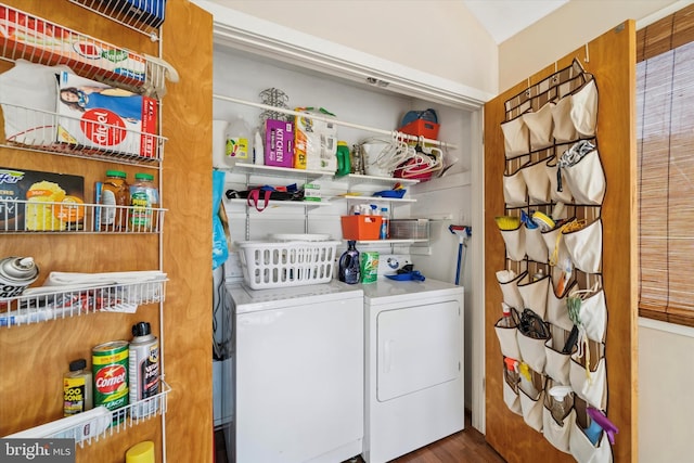 laundry room featuring washing machine and clothes dryer, laundry area, and wood finished floors