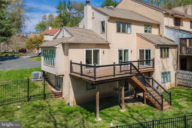 rear view of property featuring a fenced backyard, central air condition unit, a deck, and stairway