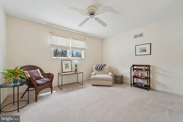 living area with baseboards, ceiling fan, carpet flooring, and visible vents