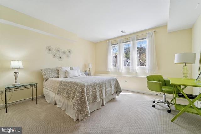 carpeted bedroom with baseboards and visible vents