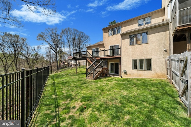 view of yard with stairs, a fenced backyard, and a deck