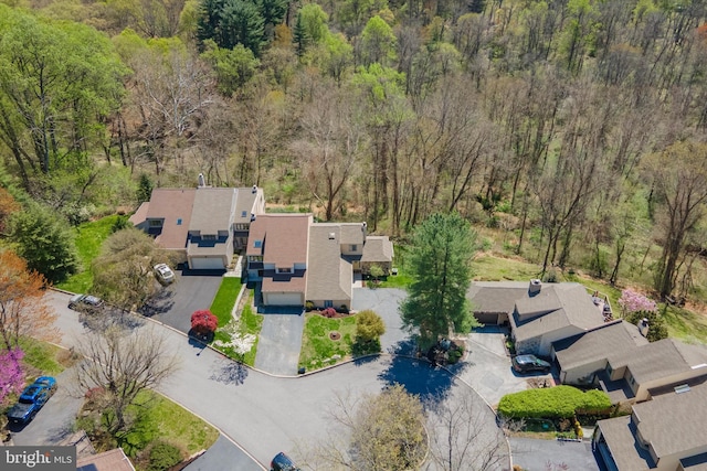 drone / aerial view with a residential view and a forest view