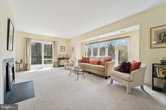 carpeted living room with a fireplace and recessed lighting