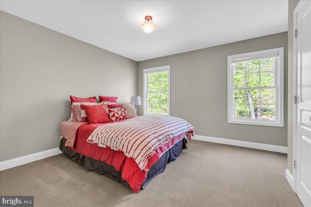 carpeted bedroom with baseboards