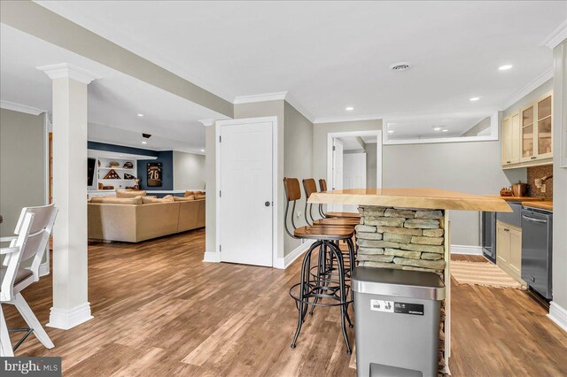 kitchen featuring light wood-style floors, baseboards, ornamental molding, and dishwasher