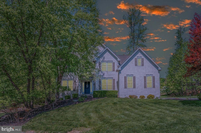 traditional home featuring a front yard