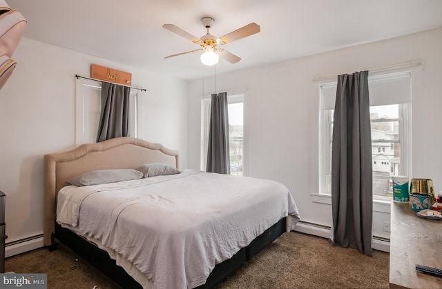 carpeted bedroom with a baseboard radiator and a ceiling fan